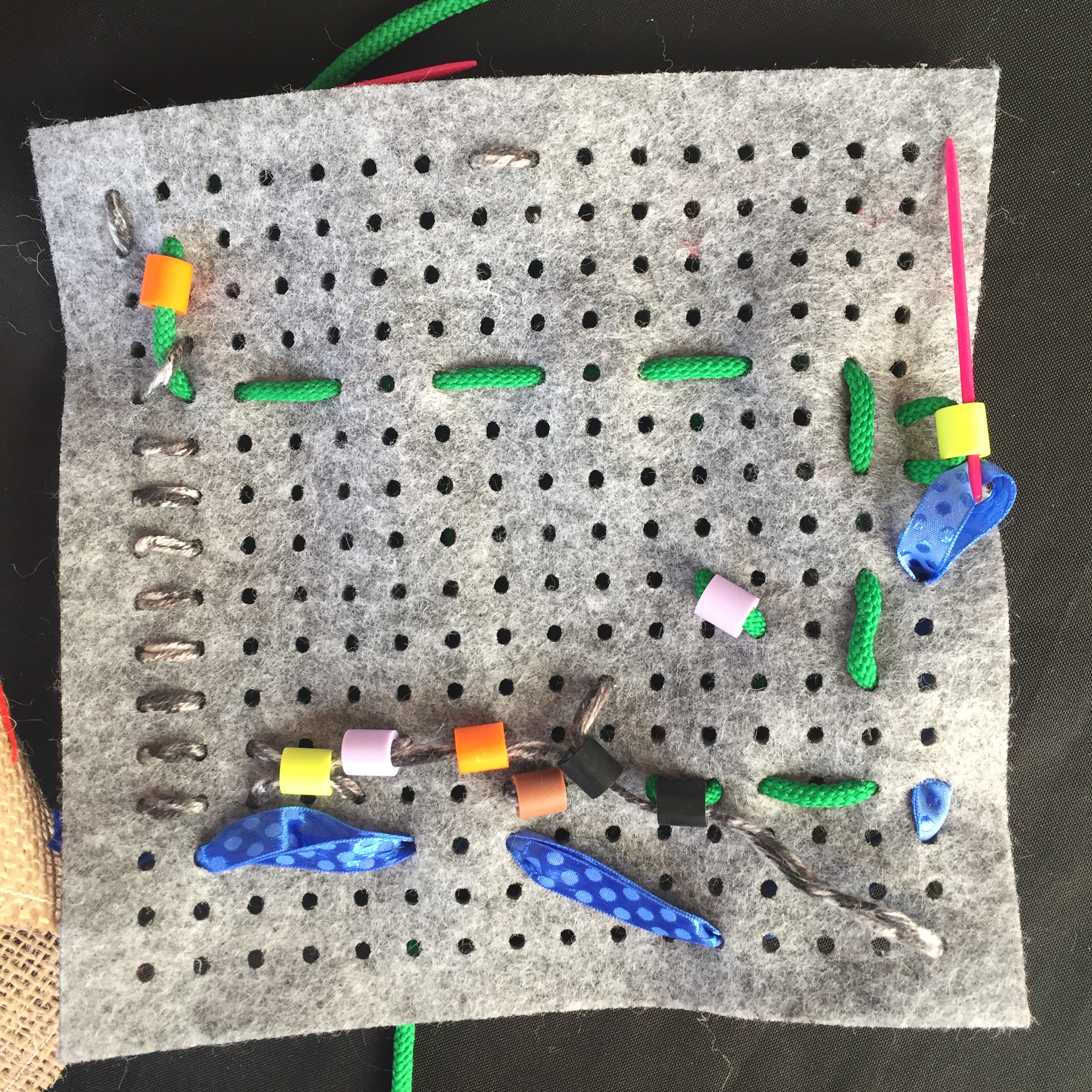 Kids weaving and stitching with beads